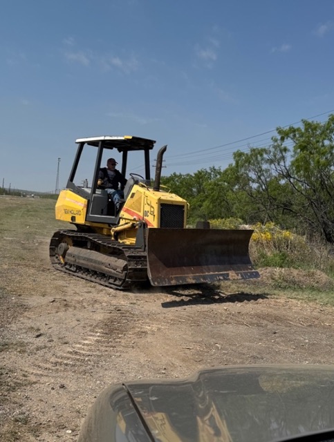 New Holland bulldozer grading a road in Big Lake, TX