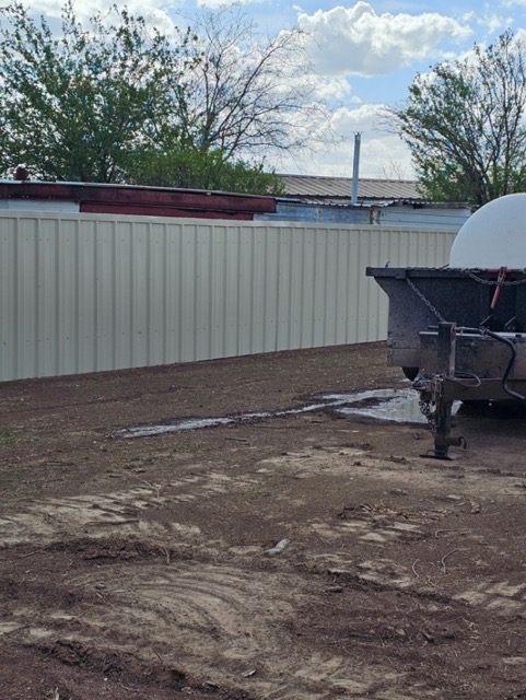 Cleared dirt lot with metal privacy fence in Abilene, TX
